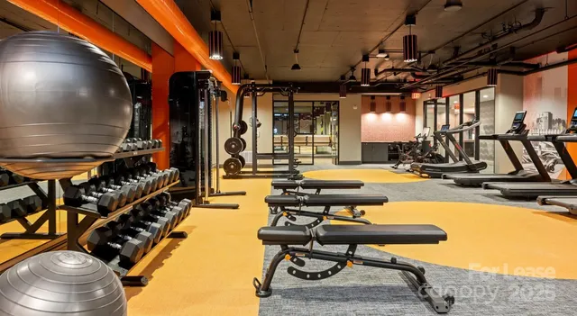 a kitchen with a stove a sink a dining table and chairs