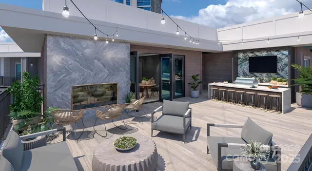 a outdoor space with furniture a flat screen tv and a fireplace