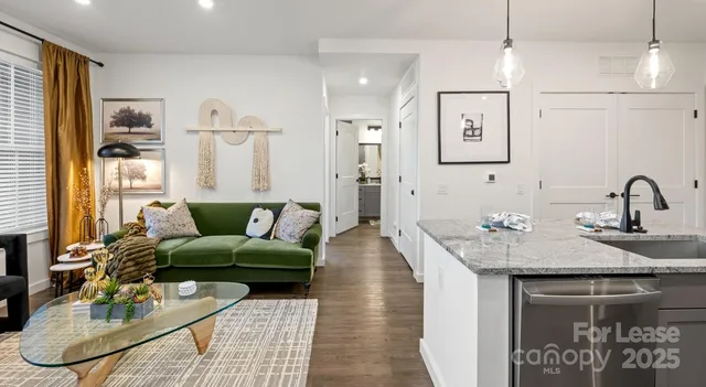 a bathroom with a granite countertop sink a toilet and a large mirror