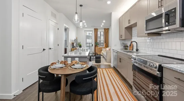 a view of a swimming pool with two lawn chairs under an umbrella
