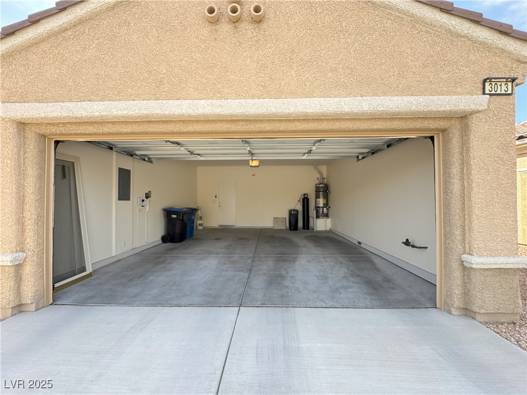 3013 Hartsville Road Henderson, NV 89052 - Photo 11 of 43 Garage with concrete driveway, strapped water heater, and electric panel