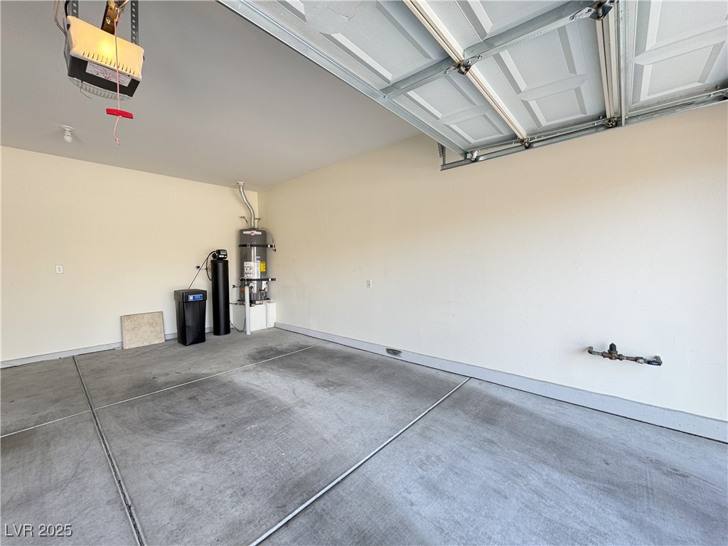 3013 Hartsville Road Henderson, NV 89052 - Photo 13 of 43 Garage featuring secured water heater, baseboards, and a garage door opener
