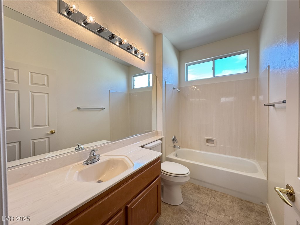 3013 Hartsville Road Henderson, NV 89052 - Photo 20 of 43 Full bath with shower combination, toilet, tile patterned flooring, and vanity