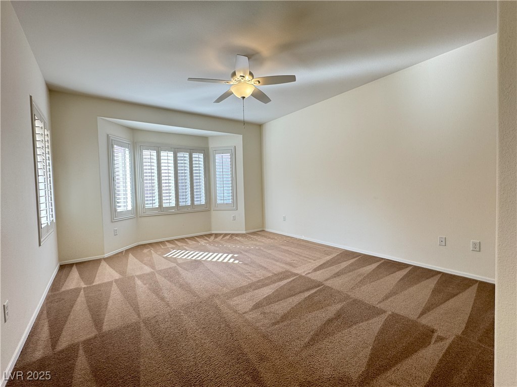 3013 Hartsville Road Henderson, NV 89052 - Photo 24 of 43 Carpeted spare room with baseboards and ceiling fan