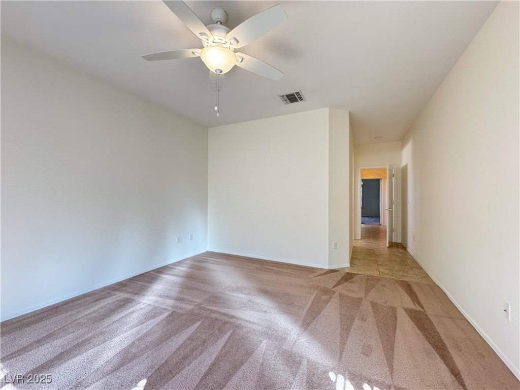 3013 Hartsville Road Henderson, NV 89052 - Photo 27 of 43 Spare room featuring baseboards, visible vents, a ceiling fan, and light carpet