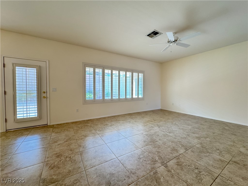 3013 Hartsville Road Henderson, NV 89052 - Photo 34 of 43 Unfurnished room featuring ceiling fan, visible vents, a healthy amount of sunlight, and tile patterned flooring