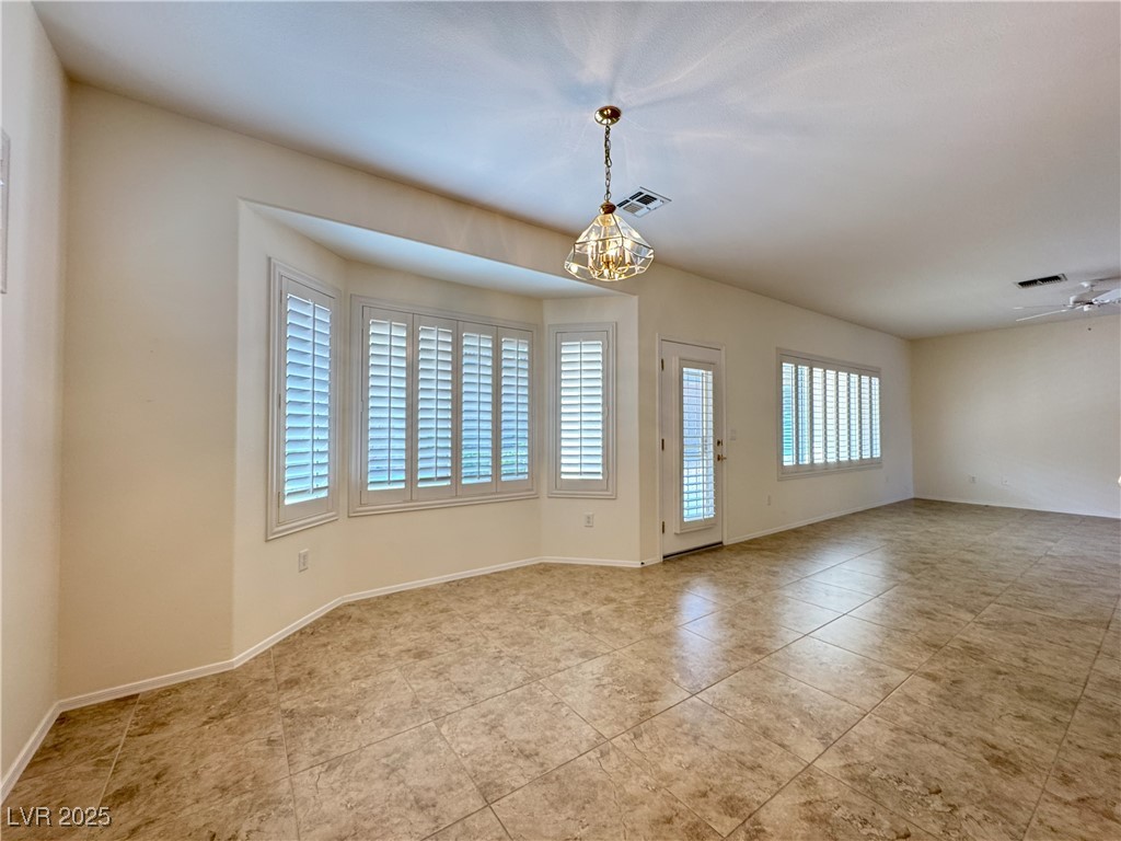3013 Hartsville Road Henderson, NV 89052 - Photo 38 of 43 Spare room with baseboards, visible vents, and a notable chandelier
