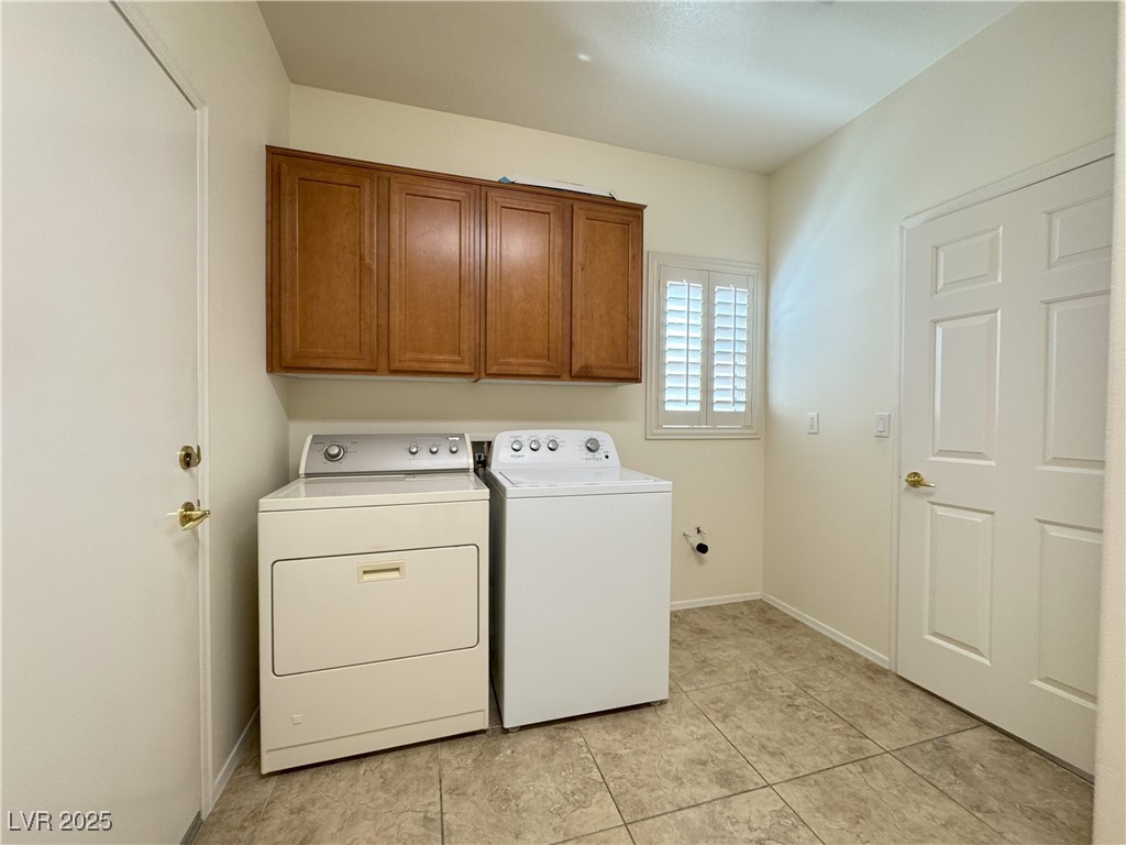 3013 Hartsville Road Henderson, NV 89052 - Photo 42 of 43 Washroom featuring washer and clothes dryer, cabinet space, baseboards, and light tile patterned floors