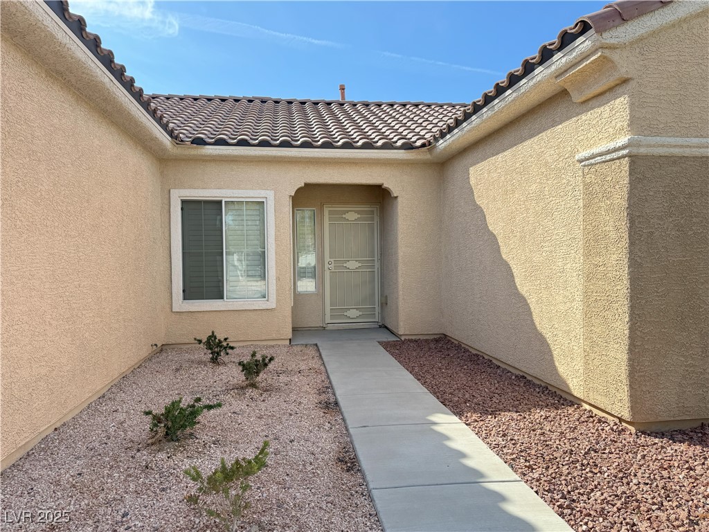 3013 Hartsville Road Henderson, NV 89052 - Photo 5 of 43 Entrance to property with a tile roof and stucco siding