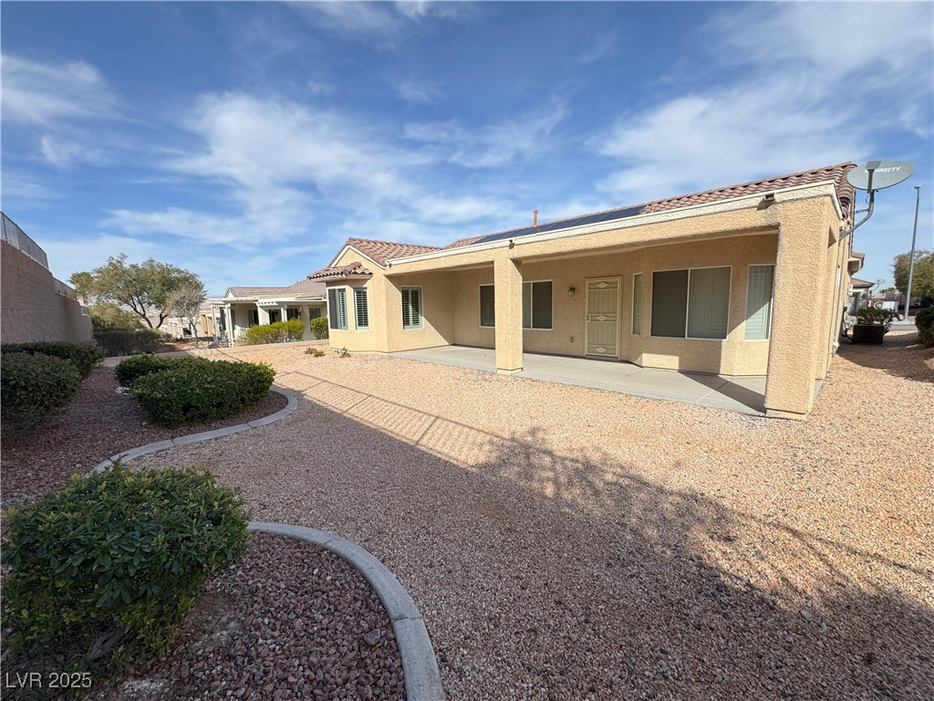 3013 Hartsville Road Henderson, NV 89052 - Photo 7 of 43 Rear view of property featuring a tile roof, stucco siding, and a patio