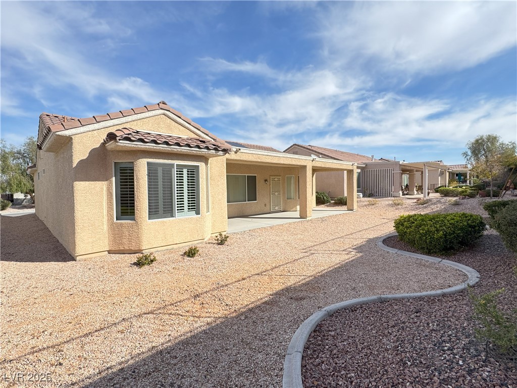 3013 Hartsville Road Henderson, NV 89052 - Photo 8 of 43 Back of property with a tiled roof, stucco siding, and a patio