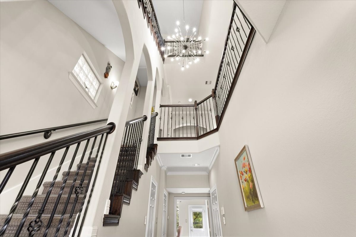 10215 Spring Shadows Park Circle Houston, TX 77080 - Photo 9 of 44 Grand three story entry way with updated lighting, and beautiful wrought iron banister along second and third story