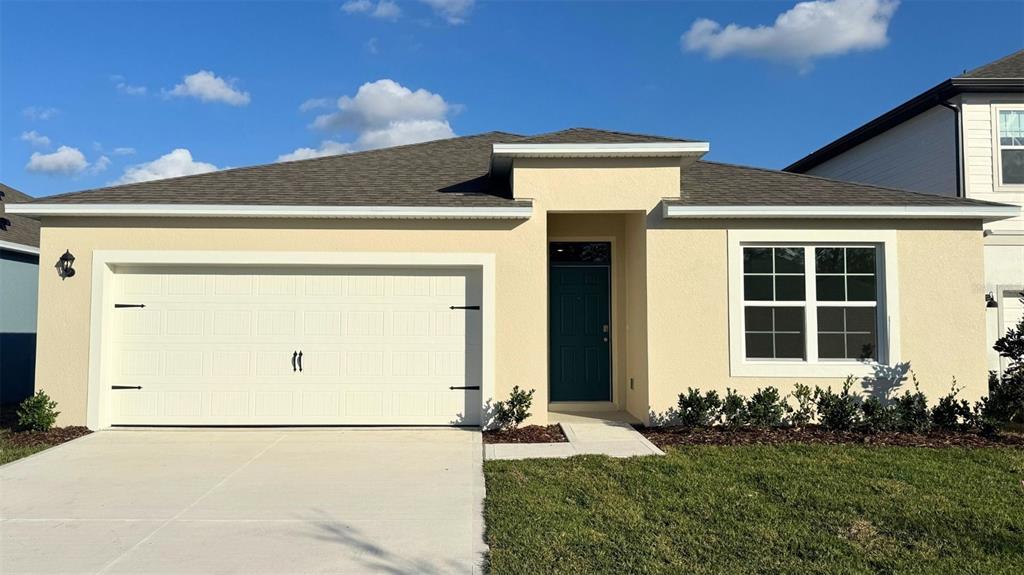 5115 Nickerbean Street Apopka, FL 32712 - Photo 1 of 16 a front view of a house with a yard