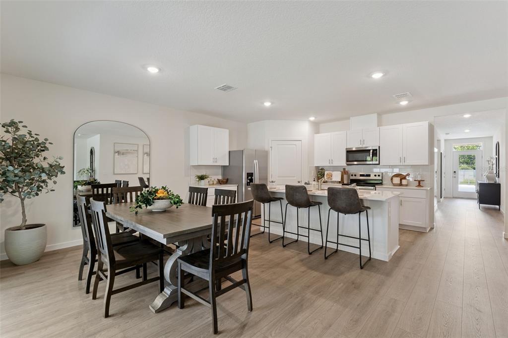 5115 Nickerbean Street Apopka, FL 32712 - Photo 5 of 16 a view of a dining room with furniture and wooden floor