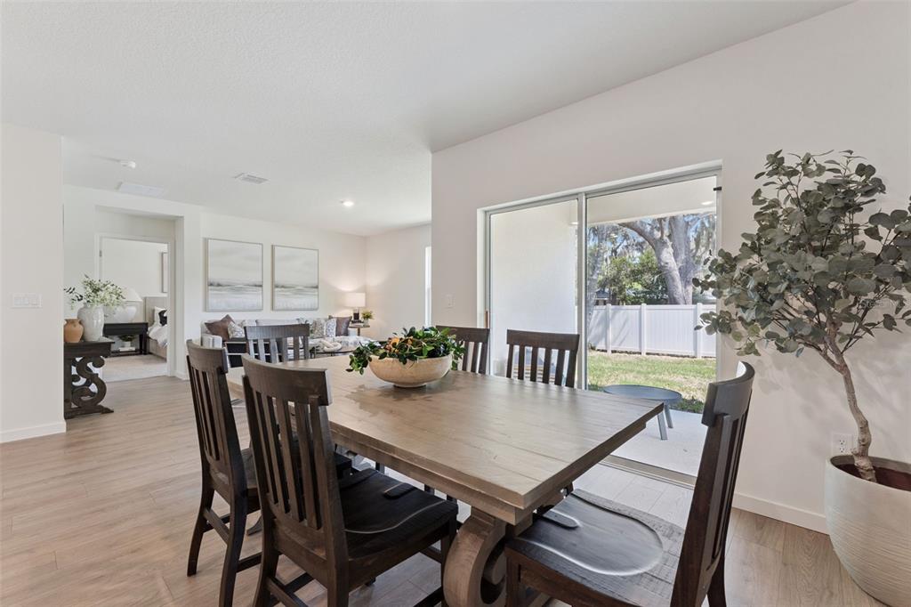 5115 Nickerbean Street Apopka, FL 32712 - Photo 6 of 16 a view of a dining room with furniture and wooden floor