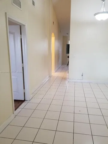 a view of an empty room and a bathroom