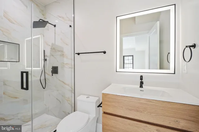 a bathroom with a sink toilet and shower