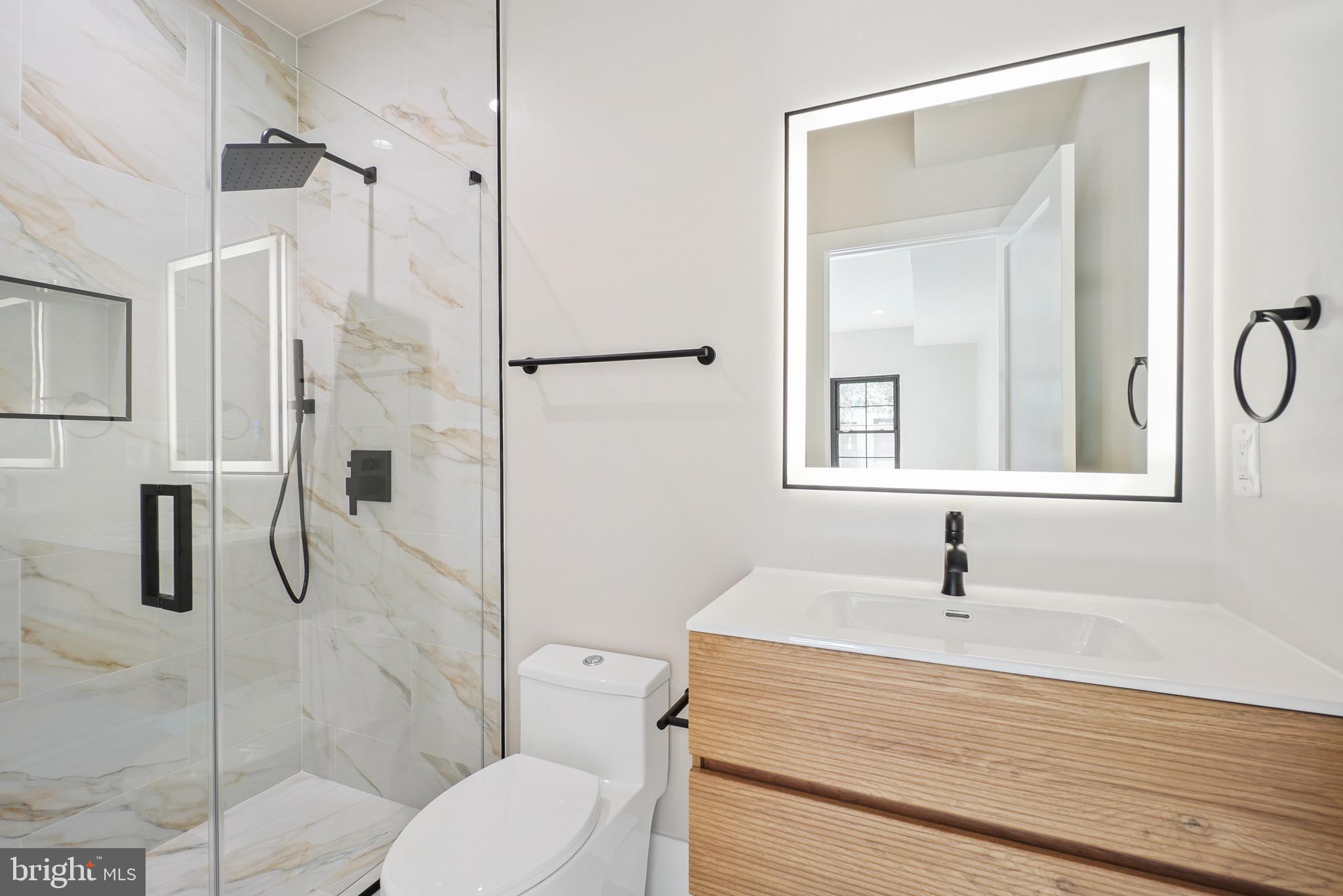 4414 Harrison Street Northwest Washington, DC 20015 - Photo 18 of 46 a bathroom with a sink toilet and shower