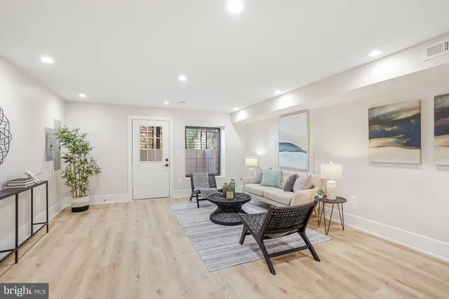 a living room with furniture and wooden floor