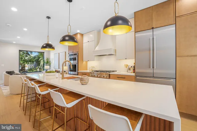 a kitchen with a table chairs and a wooden floor