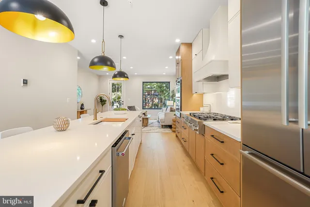 a kitchen with sink stove and refrigerator
