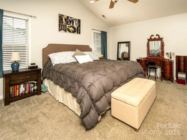 a bed room with a bed and a chair