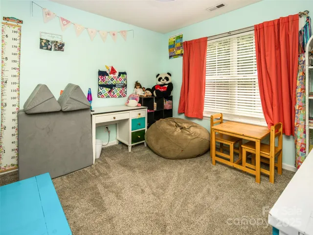 a view of a bedroom with furniture and toys