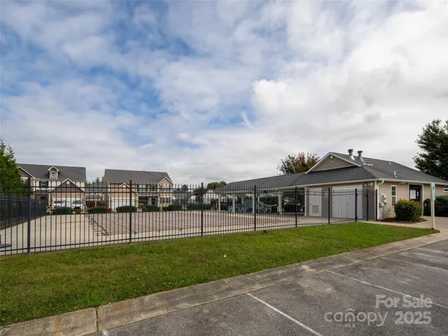 a view of a white house with a big yard and large trees