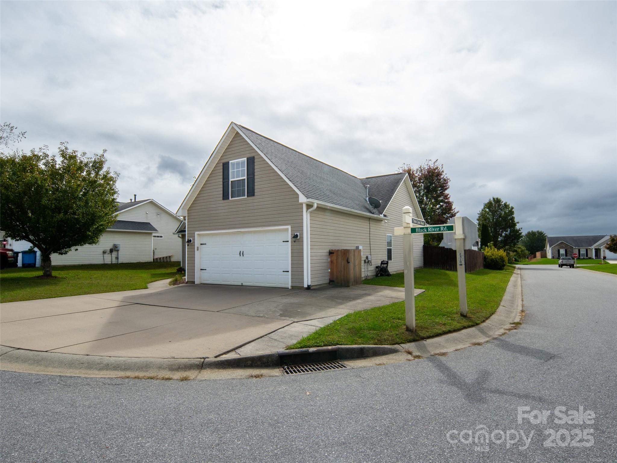 141 Black River Road Fletcher, NC 28732 - Photo 3 of 32 a front view of a house with a yard and garage