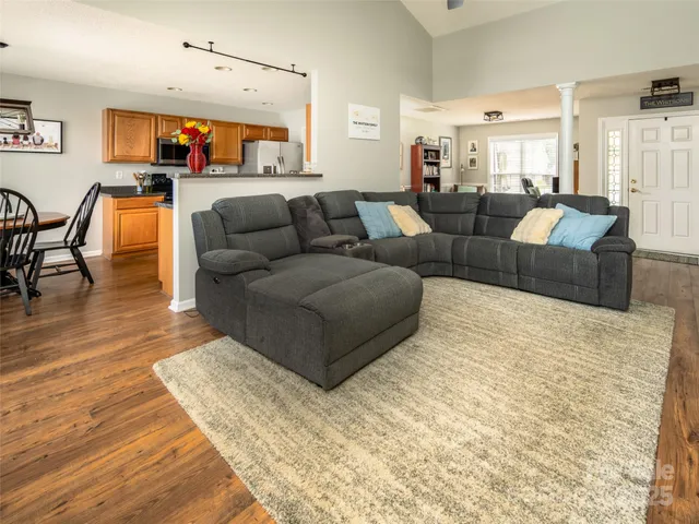 a living room with furniture a rug and a flat screen tv
