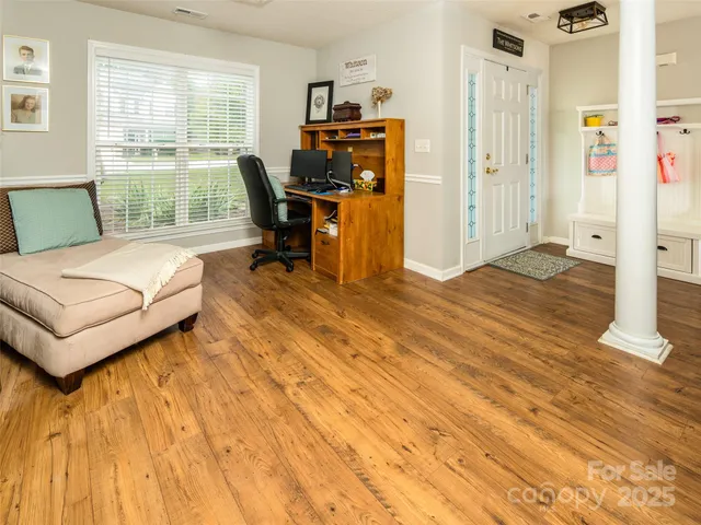 a bedroom with a bed and large windows