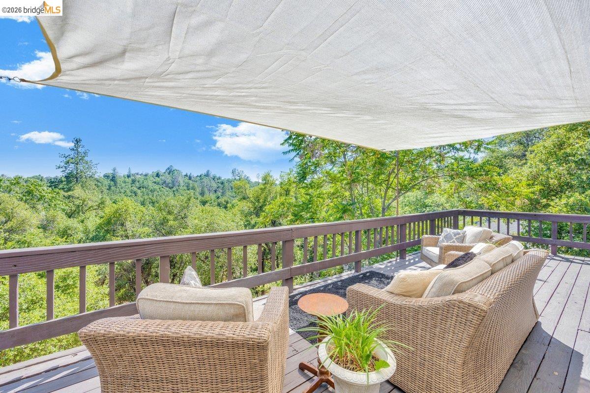 18475 Hershey Road East Tuolumne, CA 95379 - Photo 12 of 38 a balcony with wooden floor and outdoor seating