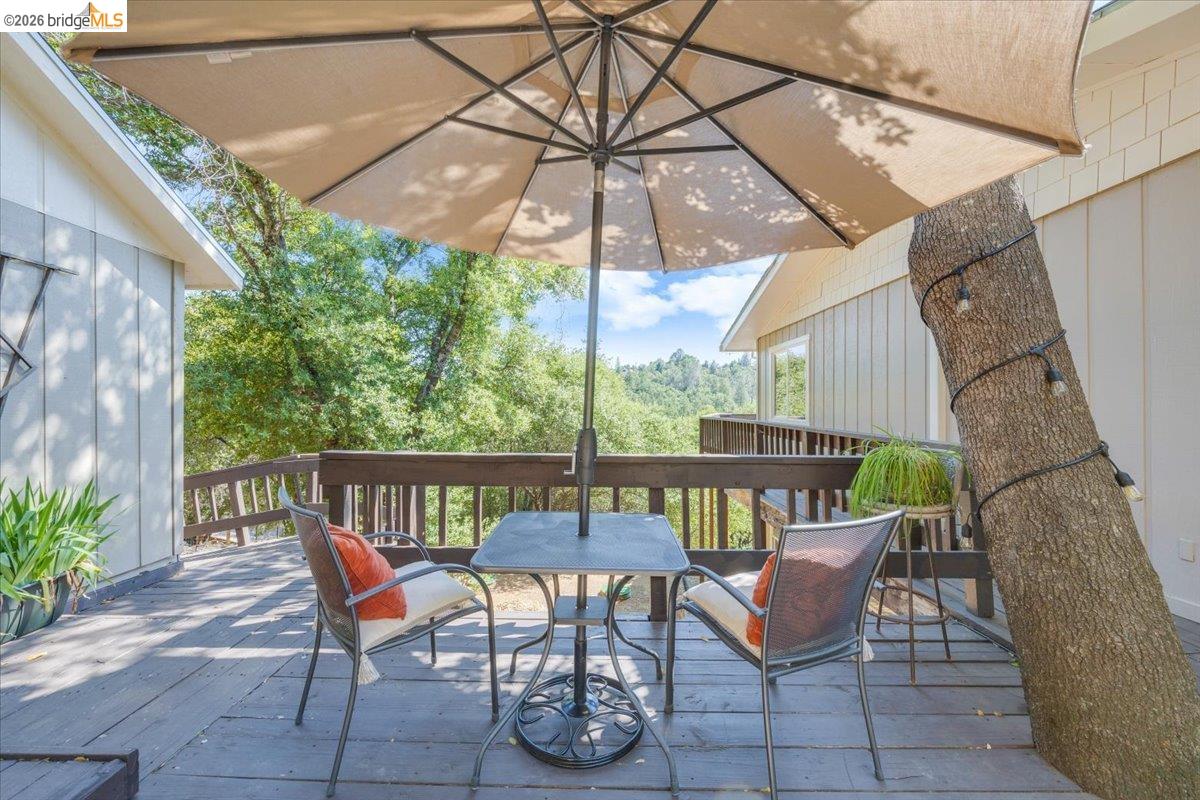 18475 Hershey Road East Tuolumne, CA 95379 - Photo 22 of 38 a view of a patio with a table and chairs under an umbrella