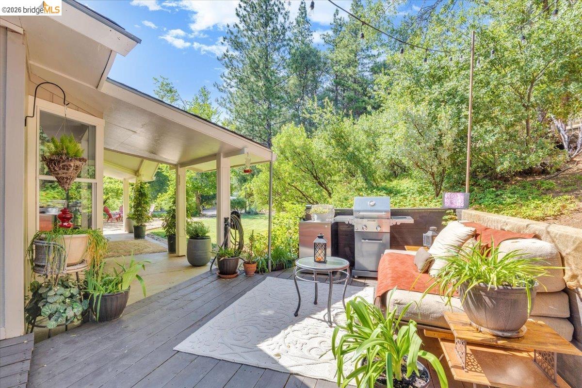 18475 Hershey Road East Tuolumne, CA 95379 - Photo 23 of 38 a view of a patio with couches table and chairs and potted plants
