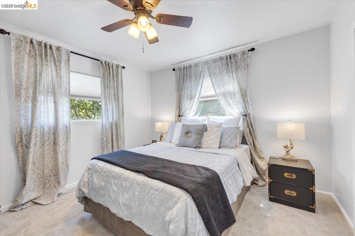 18475 Hershey Road East Tuolumne, CA 95379 - Photo 7 of 38 a bedroom with a bed and a chandelier