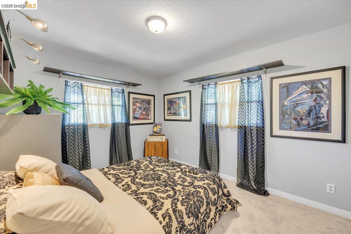 18475 Hershey Road East Tuolumne, CA 95379 - Photo 9 of 38 a bedroom with a large bed and a window