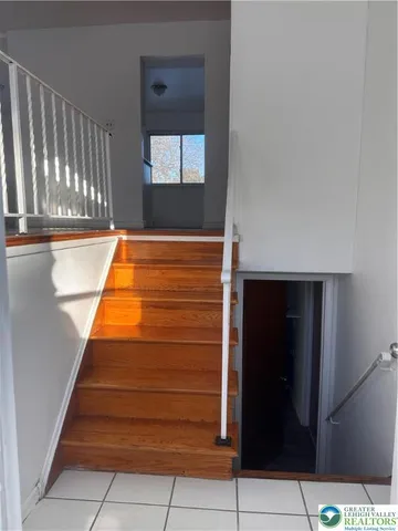 a view of a street with wooden fence