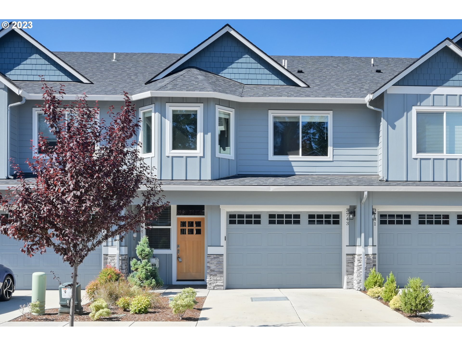 a front view of a house with a garden