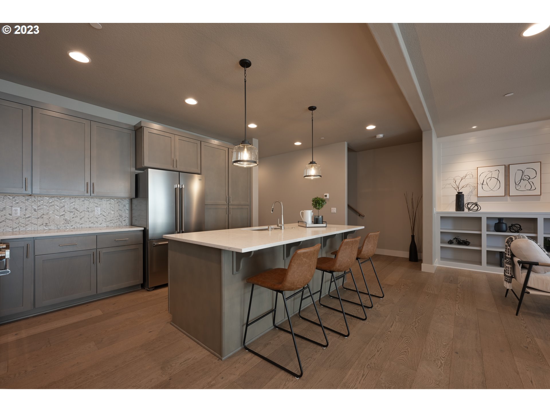 3743 Northwest 64th Avenue Camas, WA 98607 - Photo 12 of 35 a kitchen with stainless steel appliances kitchen island granite countertop a table chairs sink and cabinets
