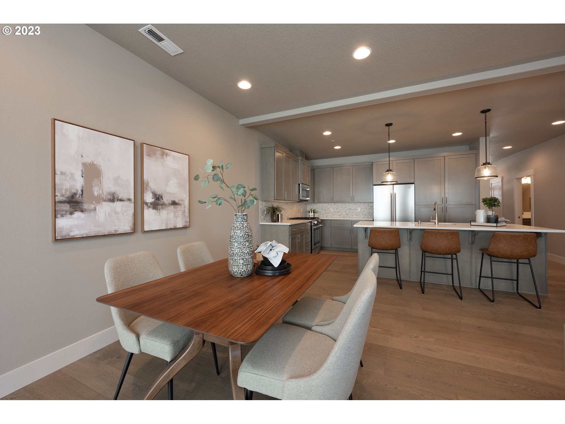 3743 Northwest 64th Avenue Camas, WA 98607 - Photo 13 of 35 a dining hall with stainless steel appliances a dining table and chairs with kitchen view