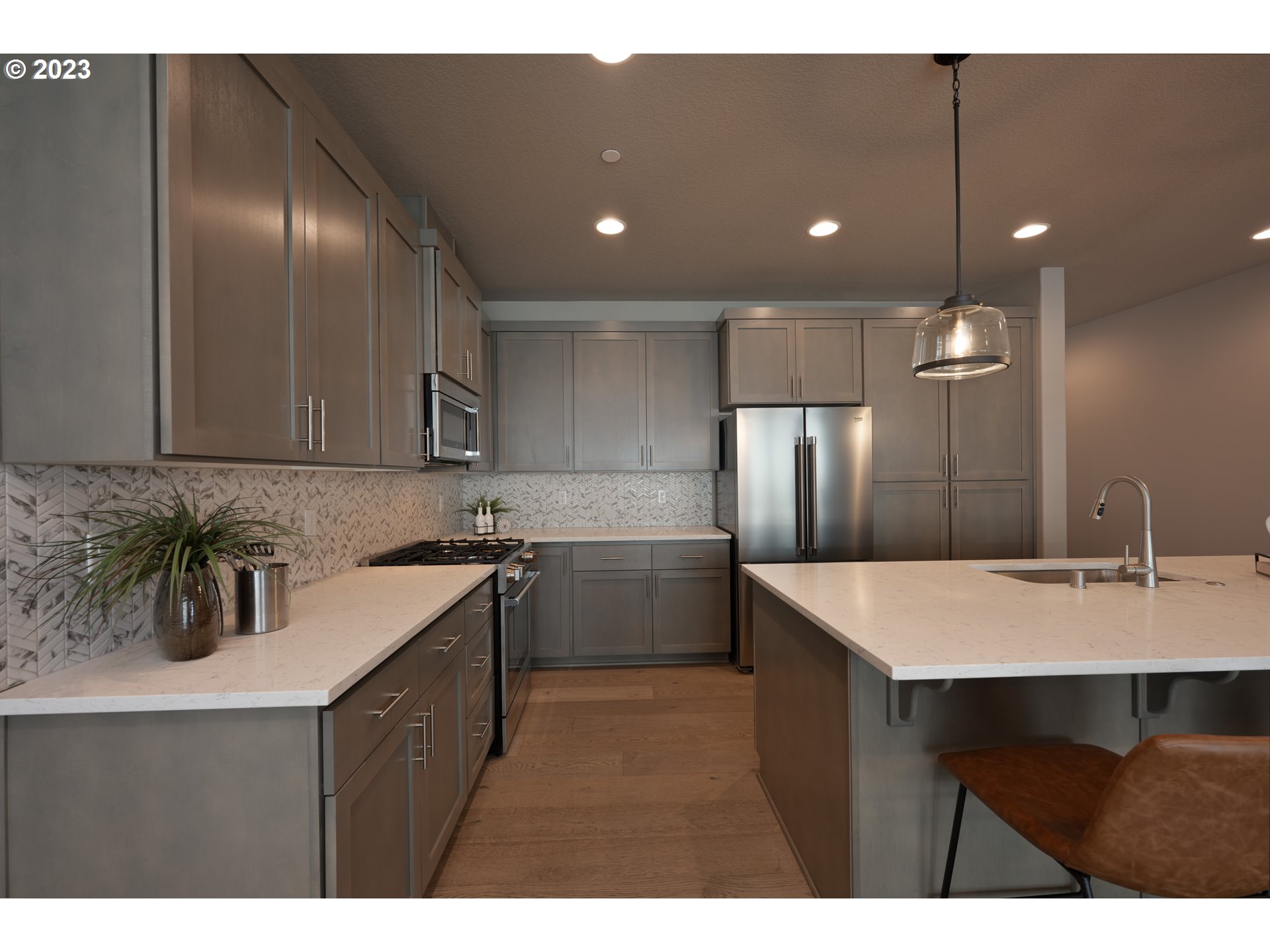 3743 Northwest 64th Avenue Camas, WA 98607 - Photo 14 of 35 a kitchen with kitchen island a sink stainless steel appliances and cabinets