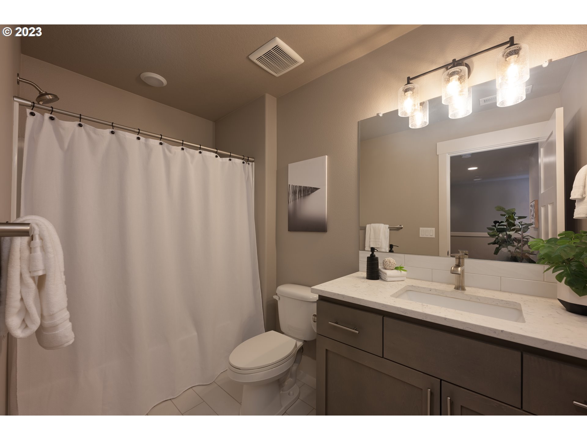 3743 Northwest 64th Avenue Camas, WA 98607 - Photo 17 of 35 a bathroom with a sink a toilet a mirror a vanity and shower