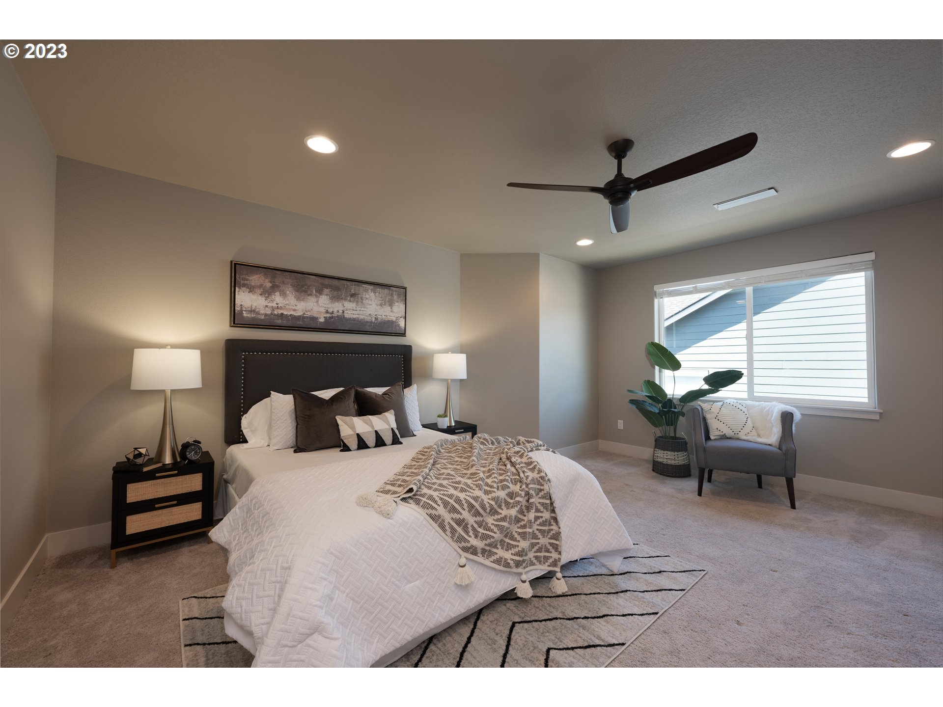 3743 Northwest 64th Avenue Camas, WA 98607 - Photo 21 of 35 a bedroom with a bed and a chandelier