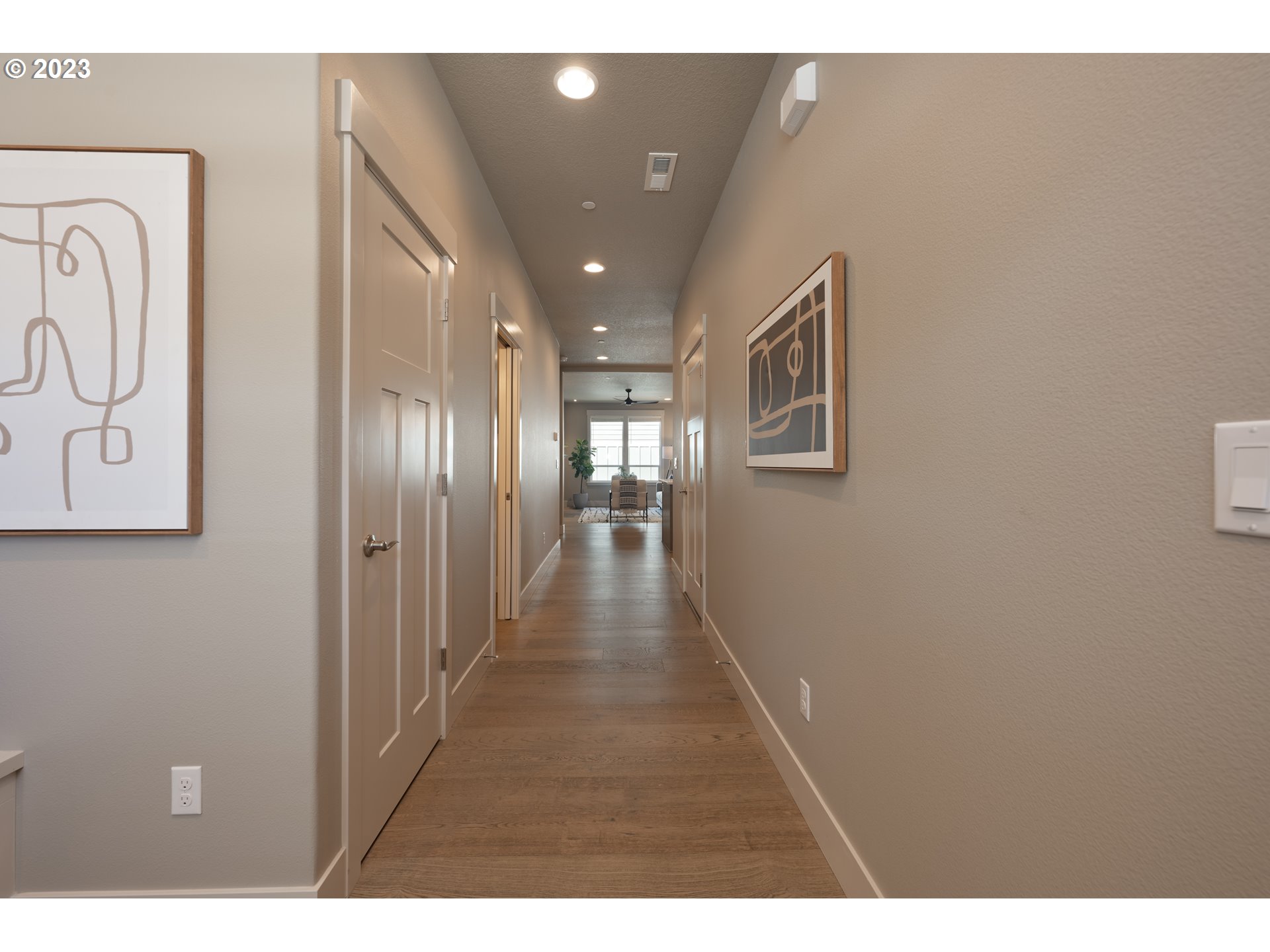 3743 Northwest 64th Avenue Camas, WA 98607 - Photo 4 of 35 a hallway with wooden floor and chandelier