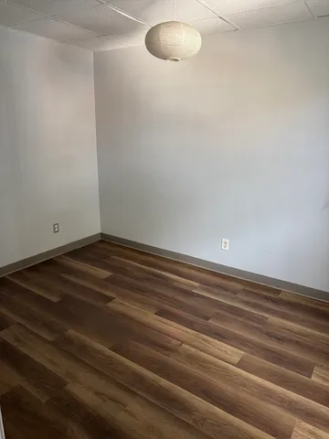 a view of room with wooden floor