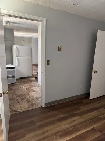 a view of a room with wooden floor and cabinet