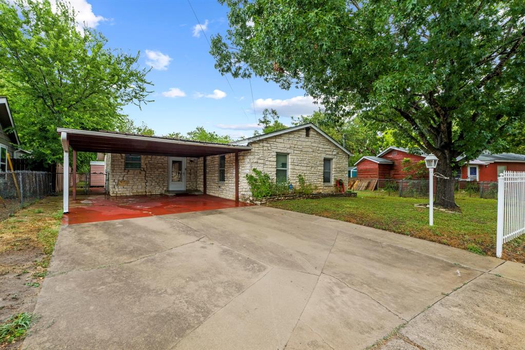 4604 Munson Street Austin, TX 78721 - Photo 1 of 18 Ranch-style house featuring concrete driveway and stone siding