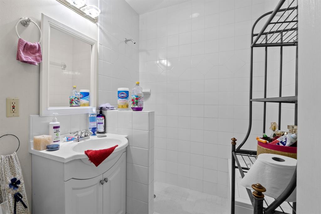 4604 Munson Street Austin, TX 78721 - Photo 15 of 18 Full bath with vanity and a walk in shower