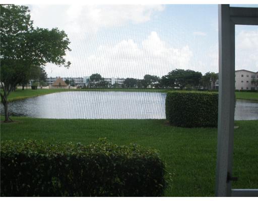 91 Brighton C, Unit 91 Boca Raton, FL 33434 - Photo 6 of 6 a view of a lake and green valley