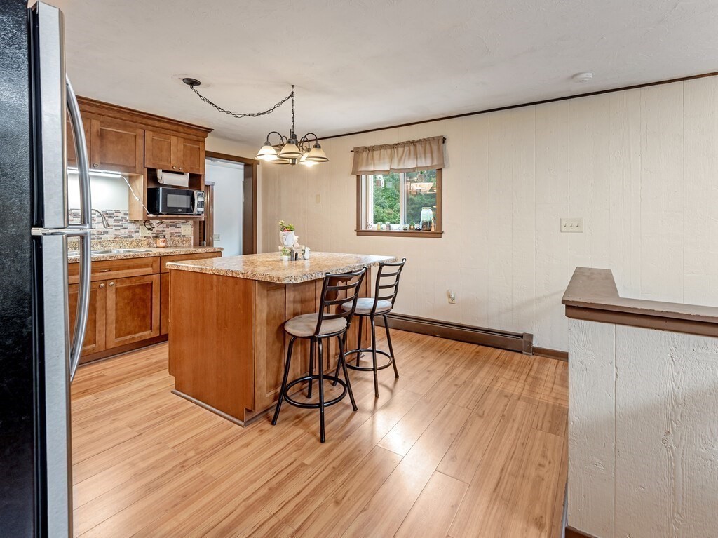 428 Keys Road Warren, MA 01585 - Photo 5 of 26 a view of a dining room with furniture window and wooden floor